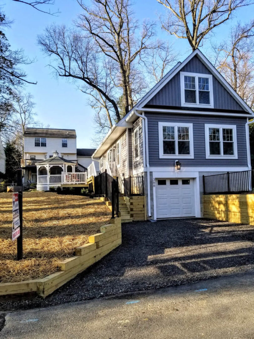 A picture of a beautiful house and a garage