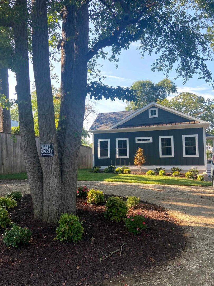 A Tree Planted in Front of a House