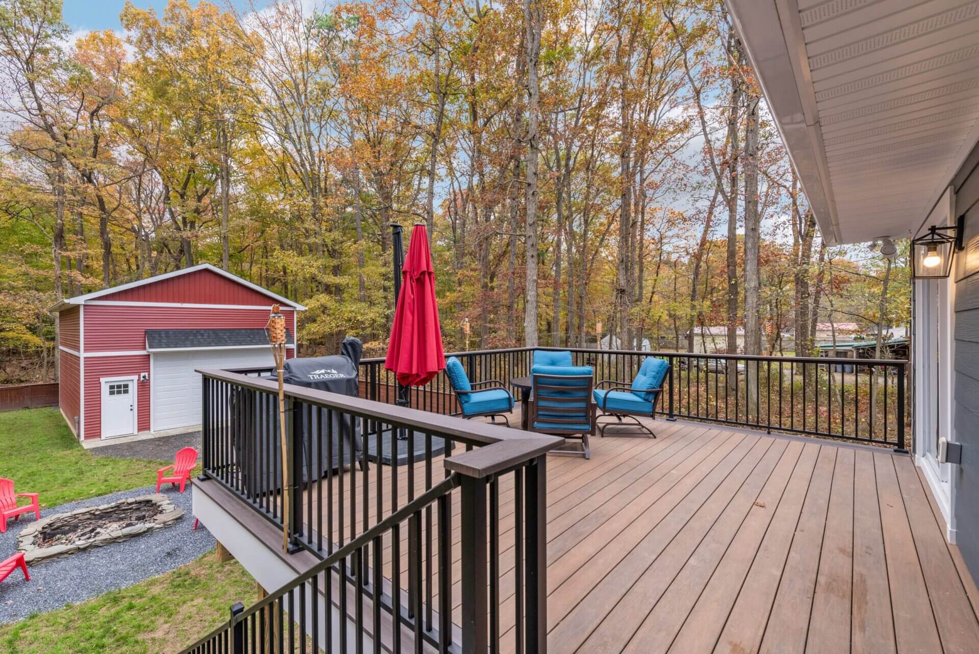 A Wooden Deck With Blue Chairs